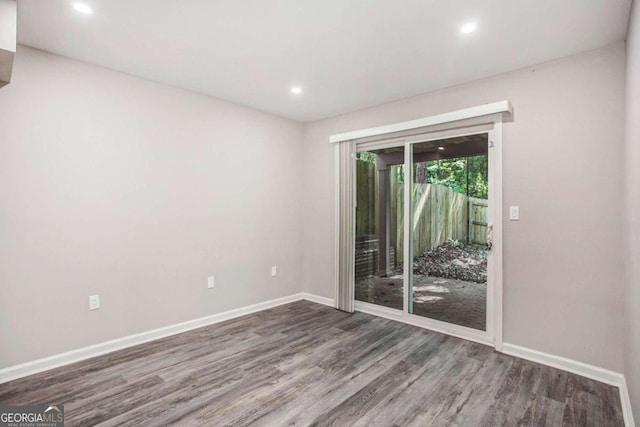 spare room with dark wood-type flooring