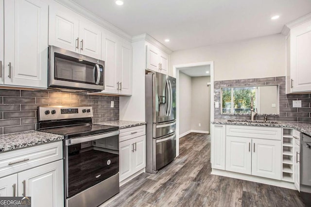 kitchen featuring appliances with stainless steel finishes, white cabinetry, sink, and dark hardwood / wood-style floors