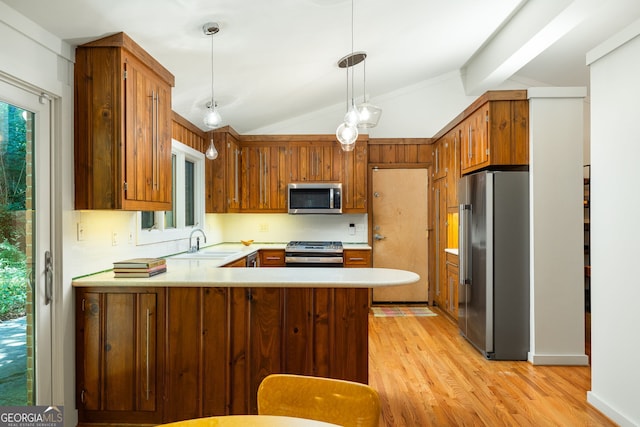 kitchen featuring appliances with stainless steel finishes, vaulted ceiling with beams, light wood-type flooring, kitchen peninsula, and pendant lighting