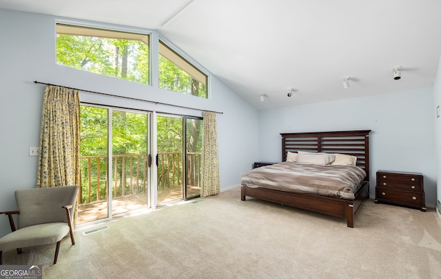 carpeted bedroom with access to outside and high vaulted ceiling