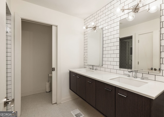 bathroom featuring vanity, tile patterned flooring, toilet, and tasteful backsplash