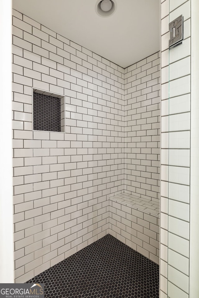 bathroom with a tile shower