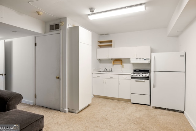 kitchen featuring light carpet, white cabinetry, sink, and white appliances