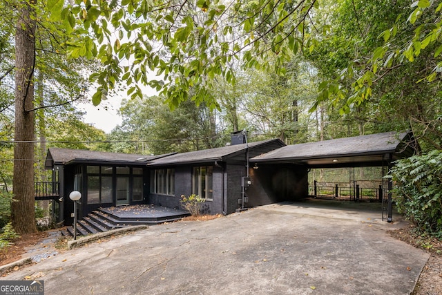 view of front of house featuring a sunroom and a carport