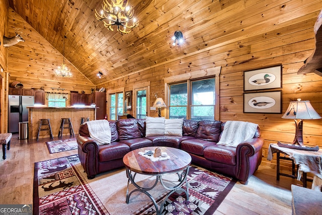 living room with wooden ceiling, light wood-type flooring, high vaulted ceiling, and wood walls