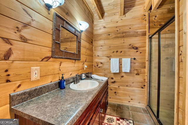 bathroom with vanity, an enclosed shower, wooden walls, and tile patterned floors