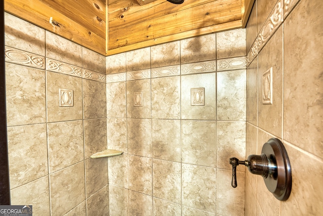 interior details featuring a tile shower