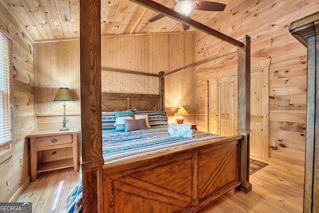 unfurnished bedroom with wood ceiling, lofted ceiling, wooden walls, and light hardwood / wood-style floors