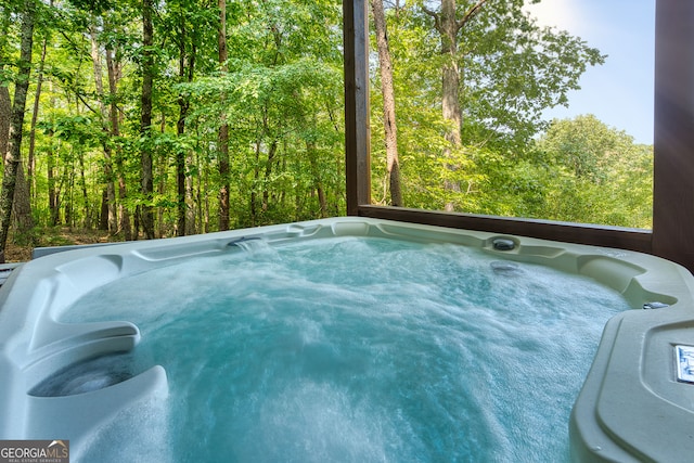 view of swimming pool with a hot tub