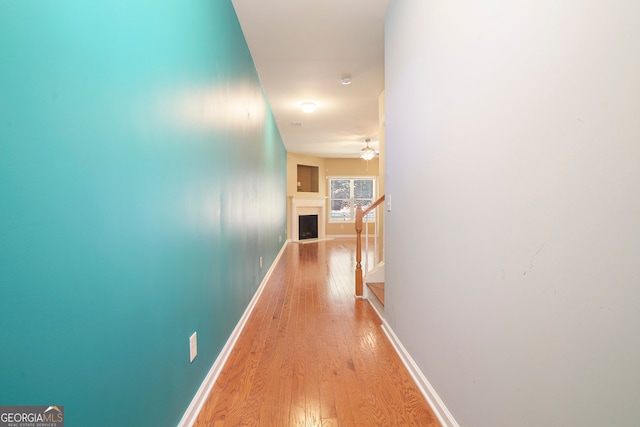 hallway with light hardwood / wood-style floors