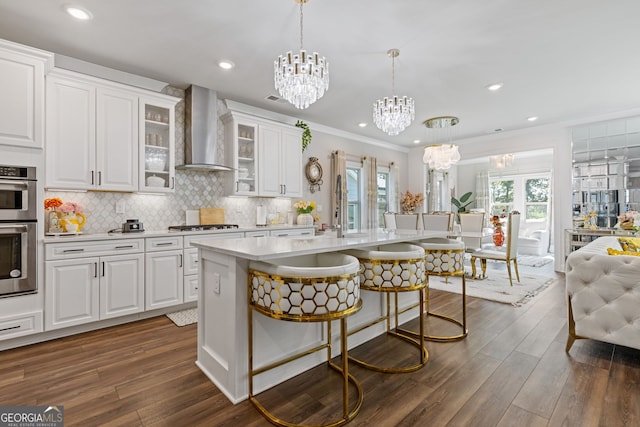 kitchen featuring wall chimney exhaust hood, white cabinets, and dark hardwood / wood-style flooring