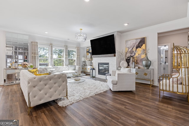 living room featuring ornamental molding, a chandelier, and dark hardwood / wood-style floors