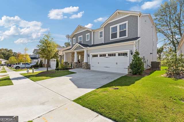 craftsman-style home featuring central air condition unit, a front lawn, and a garage