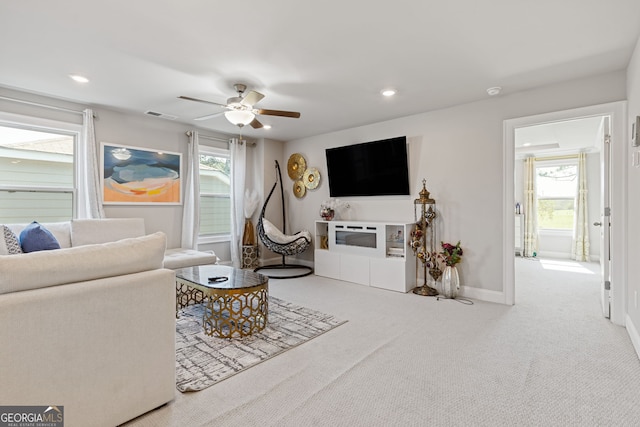 living room with carpet flooring and ceiling fan