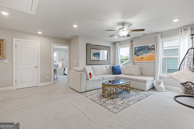 carpeted living room featuring ceiling fan