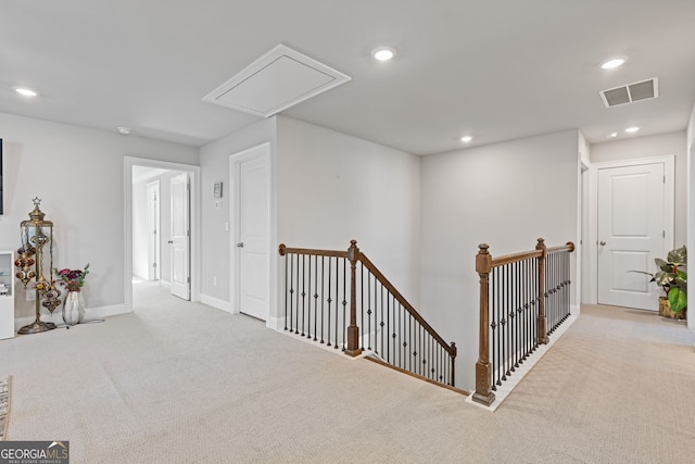 corridor with light colored carpet