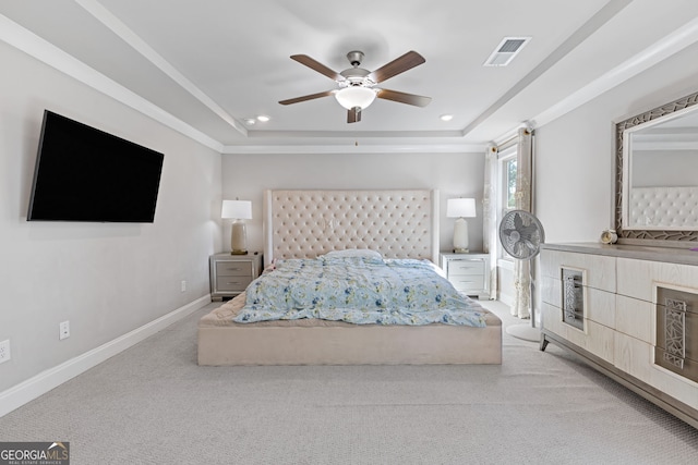 unfurnished bedroom featuring ceiling fan, a raised ceiling, and light colored carpet