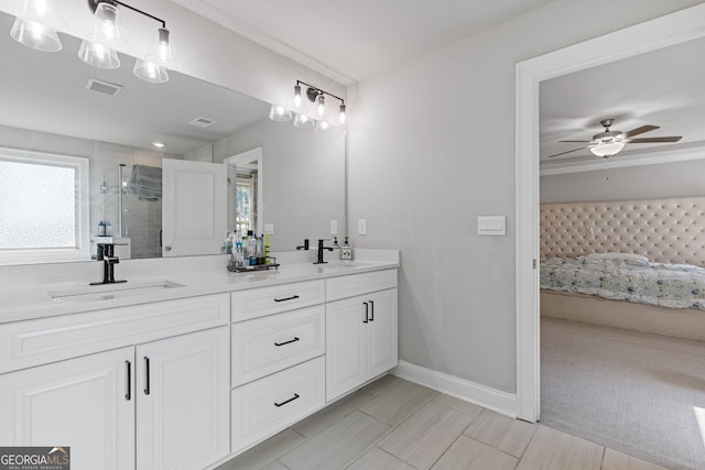 bathroom featuring vanity, a shower with shower door, and ceiling fan