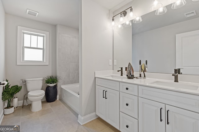 bathroom featuring vanity, toilet, tile patterned floors, and a bathing tub