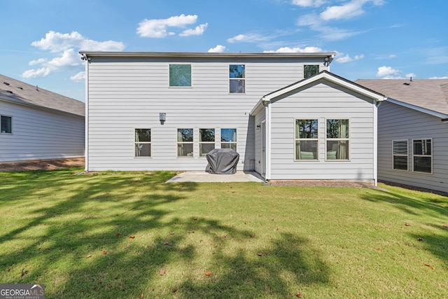 rear view of property with a yard and a patio area