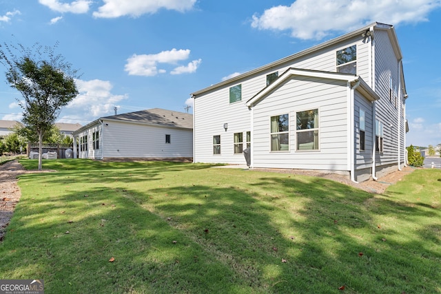 rear view of property with a yard