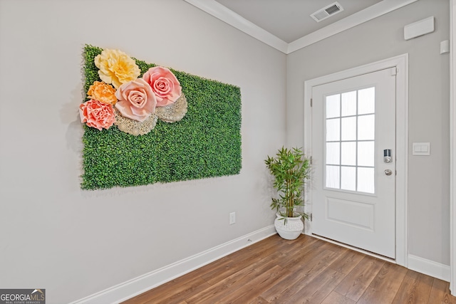 doorway to outside with crown molding and wood-type flooring