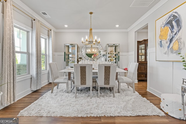 dining space with dark wood-type flooring, a chandelier, and plenty of natural light