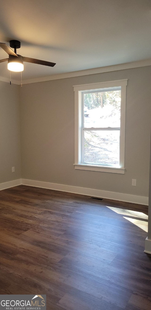 spare room with ornamental molding, ceiling fan, and dark hardwood / wood-style flooring