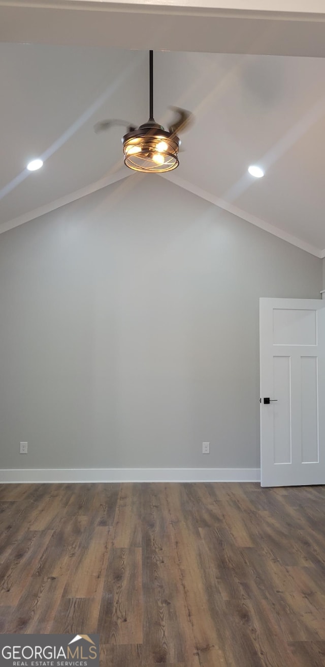 spare room featuring vaulted ceiling, ceiling fan, and dark hardwood / wood-style flooring