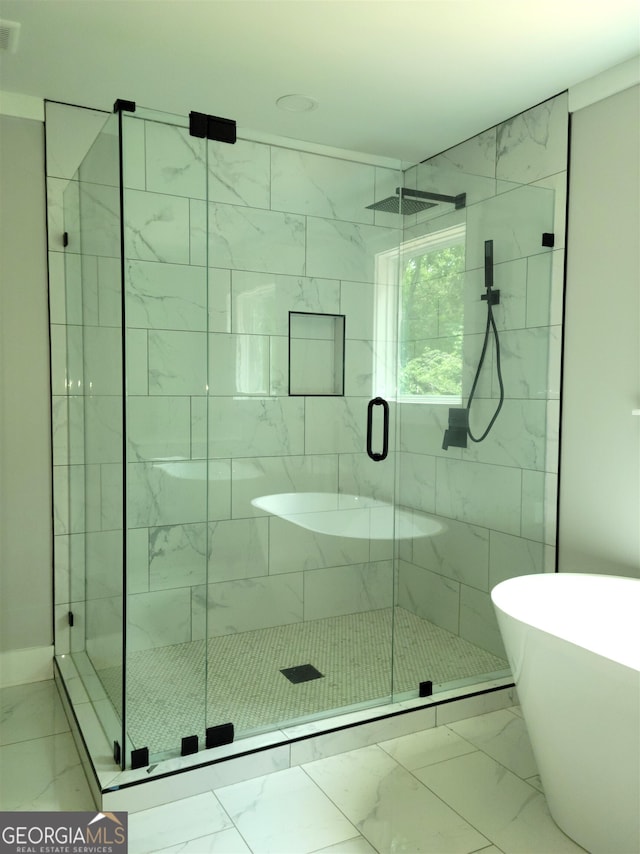 bathroom featuring shower with separate bathtub