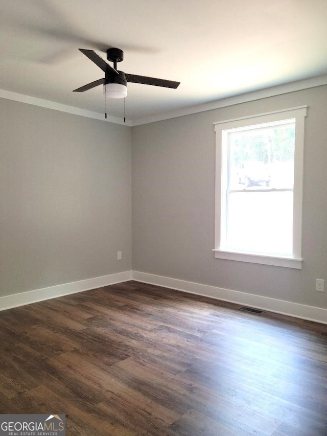 unfurnished room with crown molding, dark hardwood / wood-style floors, and ceiling fan