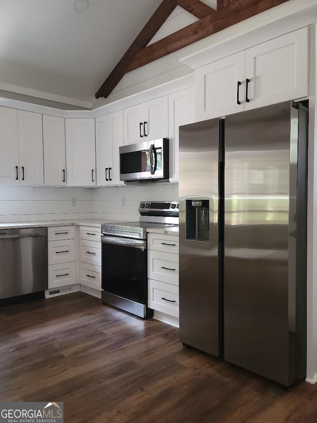 kitchen featuring white cabinets, vaulted ceiling with beams, stainless steel appliances, and dark hardwood / wood-style flooring