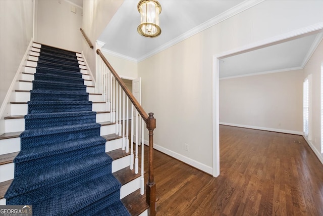 staircase featuring hardwood / wood-style floors and crown molding