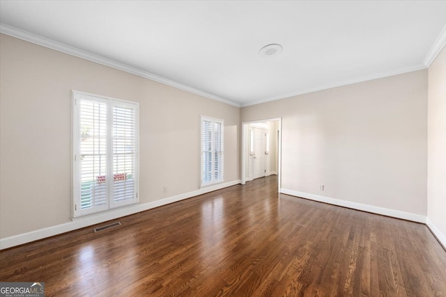 spare room featuring ornamental molding and dark wood-type flooring