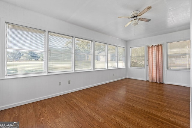 unfurnished sunroom featuring ceiling fan