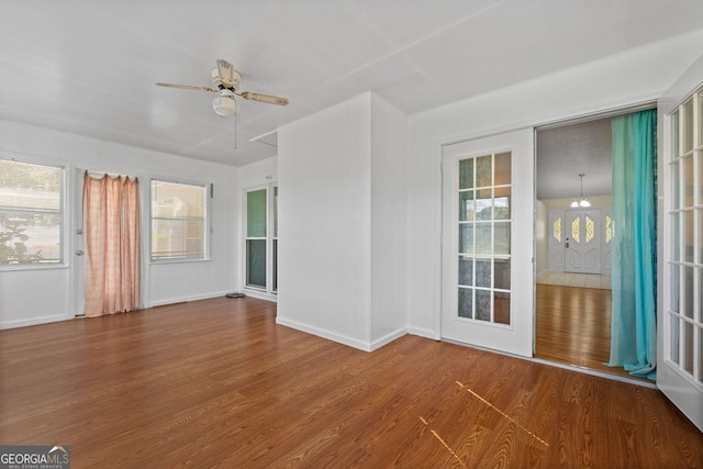 empty room with hardwood / wood-style floors, ceiling fan, and plenty of natural light