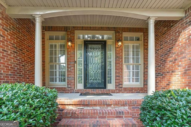 view of exterior entry with a porch