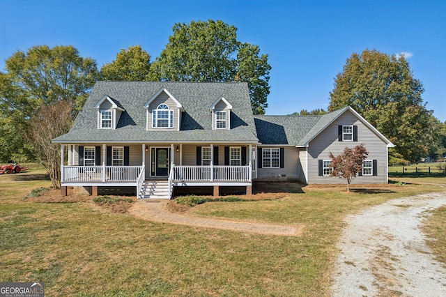 cape cod-style house featuring covered porch and a front yard