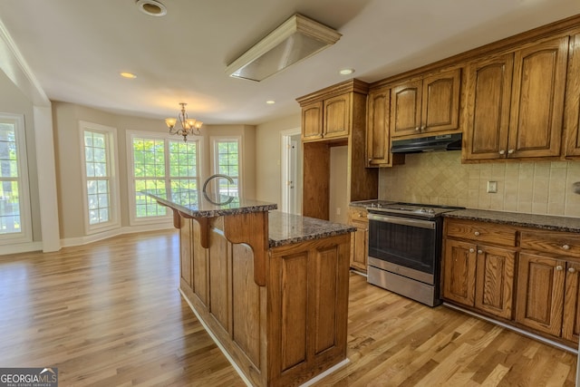 1201 Keencheefoonee Rd, Rutledge, GA 30663 - kitchen featuring light wood finished floors, brown cabinetry, under cabinet range hood, and electric range