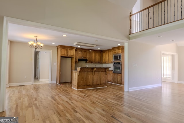 1201 Keencheefoonee Rd, Rutledge, GA 30663 - kitchen with open floor plan, brown cabinets, appliances with stainless steel finishes, and a chandelier