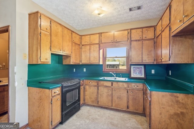 kitchen featuring sink, electric range, and a textured ceiling