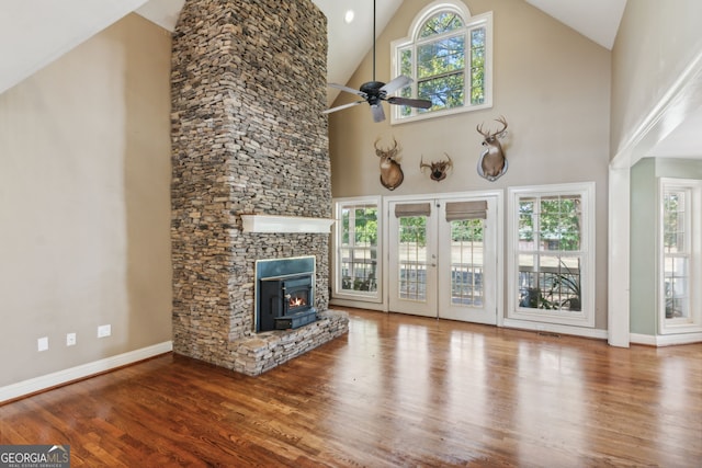 unfurnished living room with hardwood / wood-style flooring, high vaulted ceiling, and a wealth of natural light