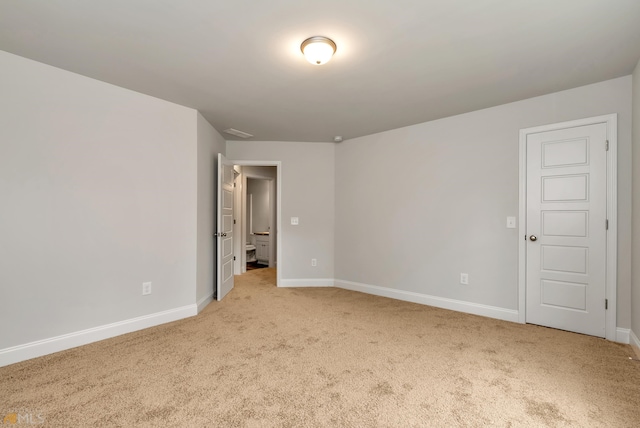 empty room featuring light colored carpet