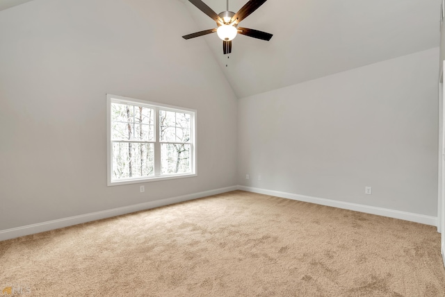 carpeted empty room with ceiling fan and high vaulted ceiling