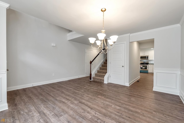 interior space featuring hardwood / wood-style flooring, crown molding, and an inviting chandelier