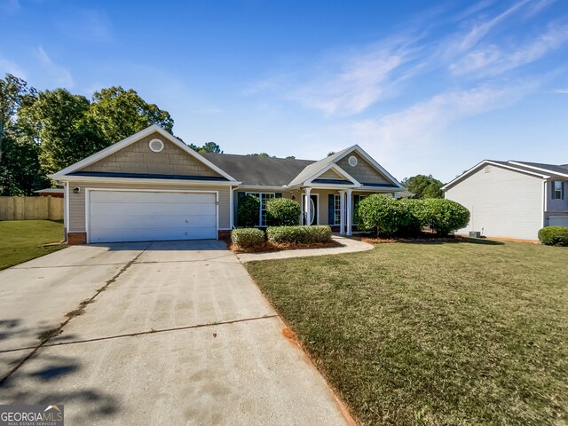 single story home featuring a front lawn and a garage