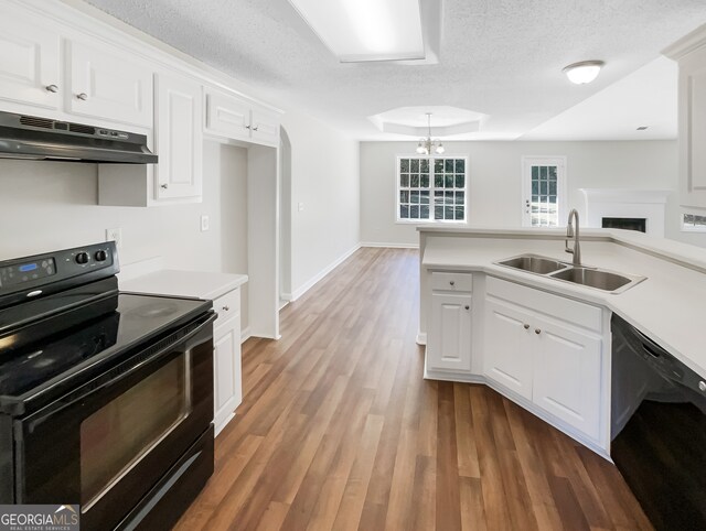 kitchen featuring sink, black appliances, white cabinetry, and dark hardwood / wood-style flooring