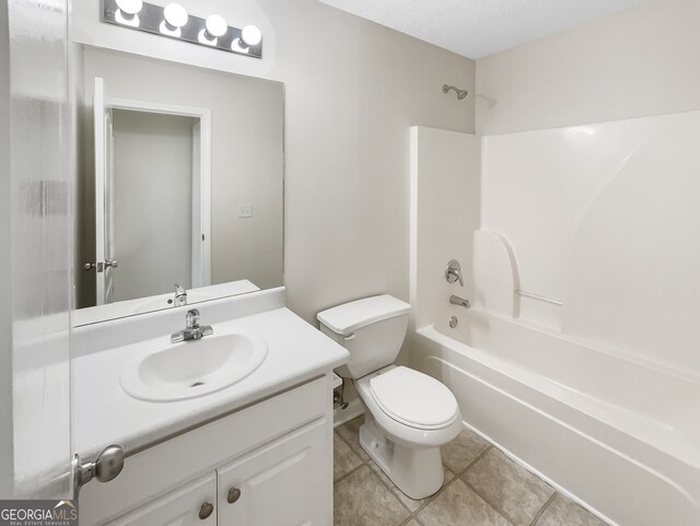 full bathroom featuring toilet, tile patterned flooring, shower / tub combination, vanity, and a textured ceiling