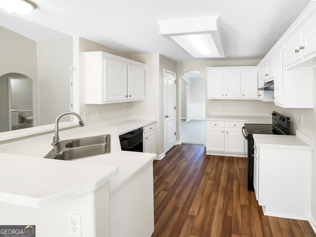 kitchen featuring black appliances, sink, kitchen peninsula, and white cabinets