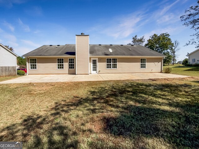 back of house featuring a yard and a patio area